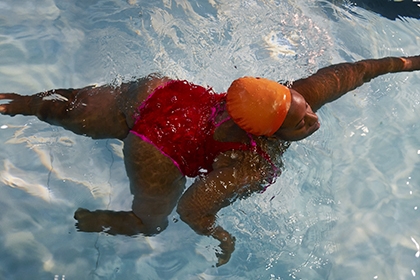 An overhead shot of Glynis swimming in a pool.