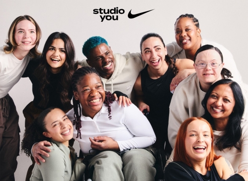 A group of women with a variety of characteristics smile for a posed shot.