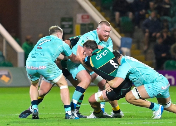 Fyn Brown of Northampton Saints tries to break away from the Bedford Blues defence during a rugby union game.