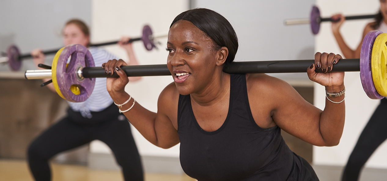 A black woman working out at a fitness class