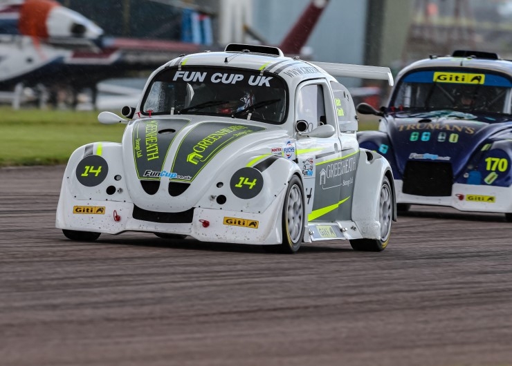 Two Volkswagen Beetles on the track during a motorsport event called Fun Cup UK.