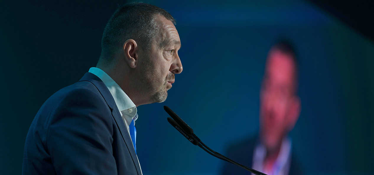 Chris Boardman speaks at a lectern during COP29 in Azerbaijan.