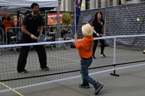 Adults and youngsters play pickleball at a pop-up Pickleball England stall during the Sikh Games in Trafalgar Square, London.