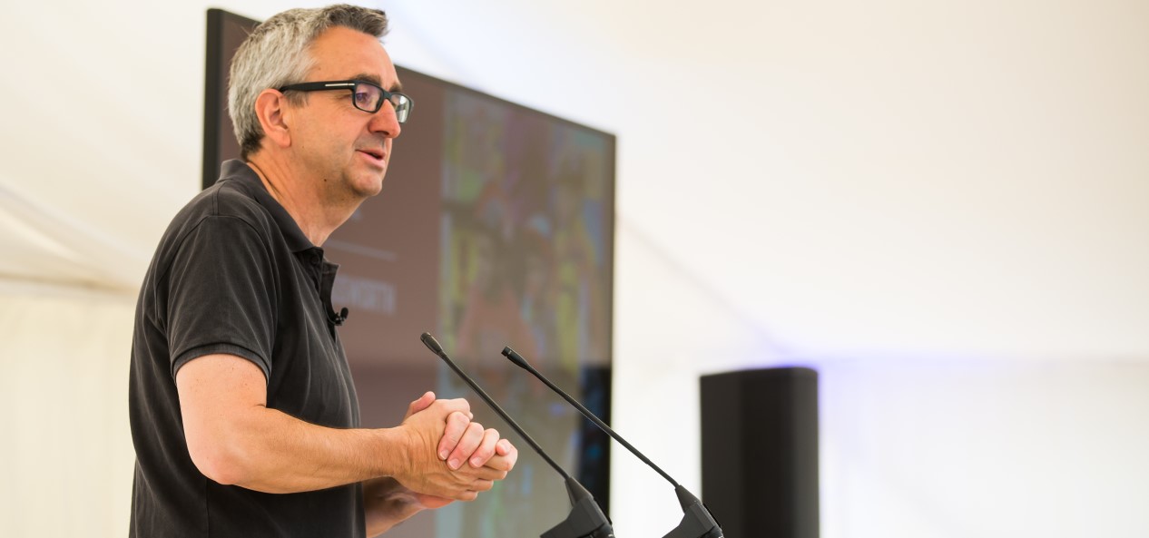 Tim Hollingsworth speaks from a lectern at an event.