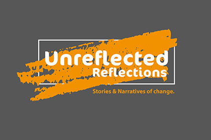 Logo of Unreflected reflections. The name is written in white font over an orange and grey background. Underneath it says "Stories and narratives of change."