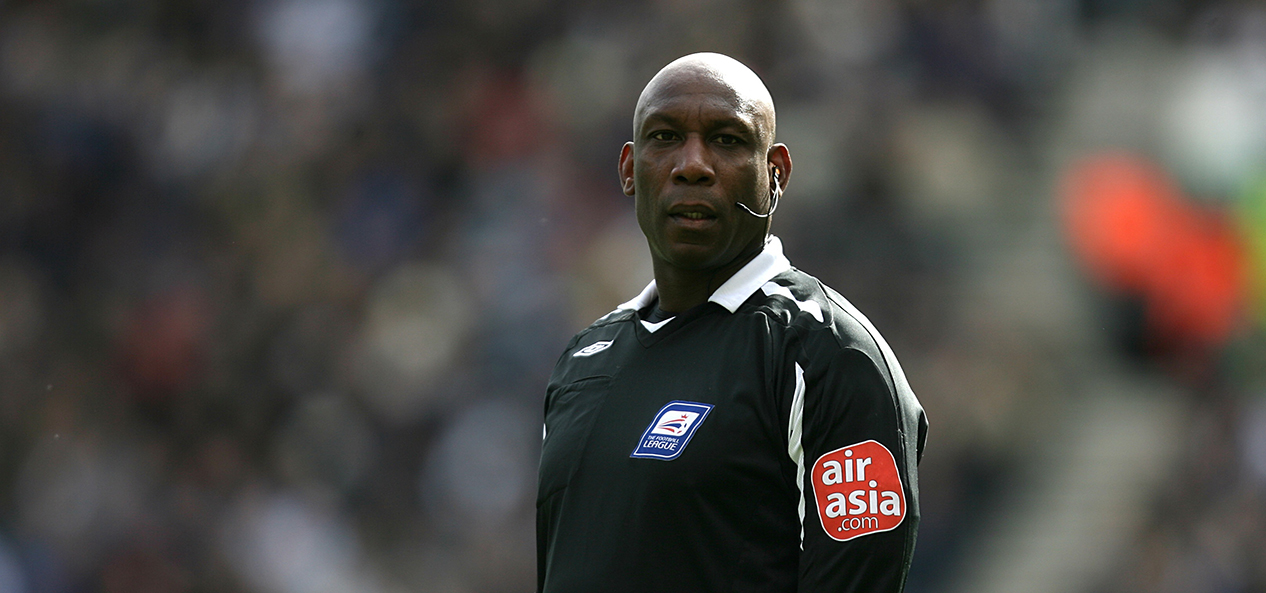 Black football referee Uriah Rennie, officiating a Football League match