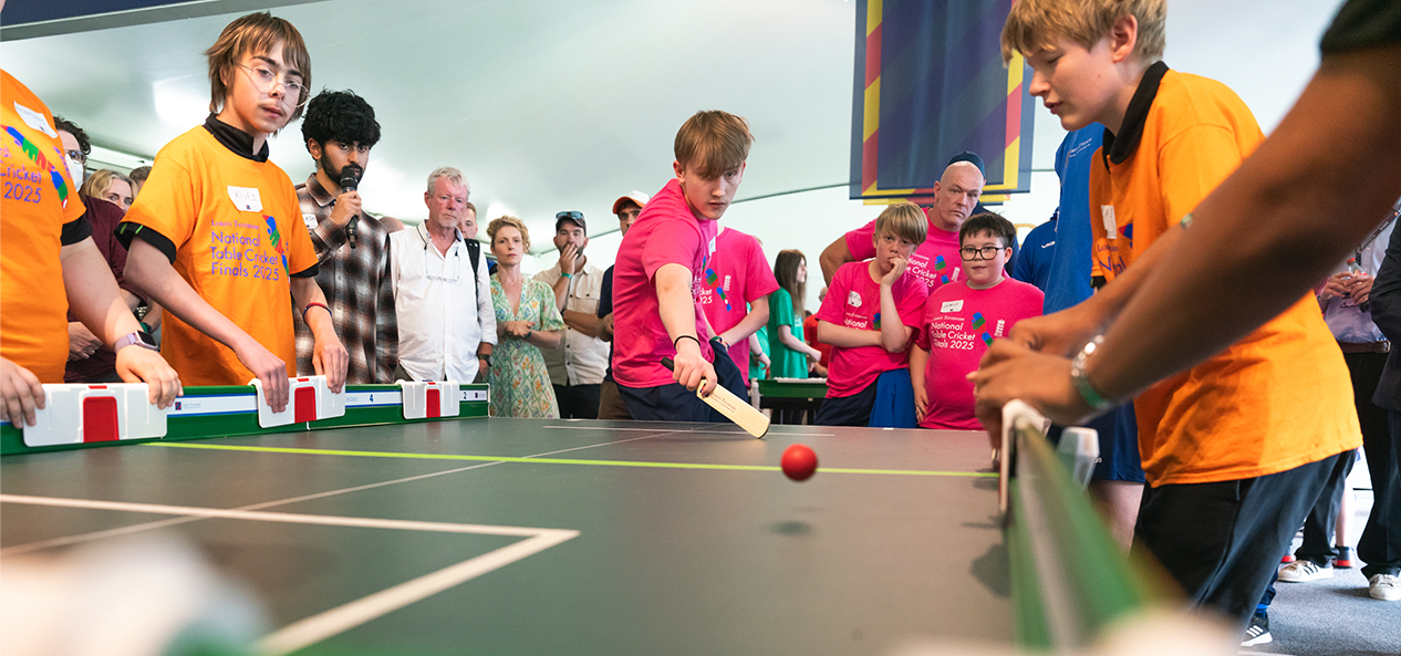 Young people take part in a mini cricket game on a table during the Disability Cricket Day at Lord's.